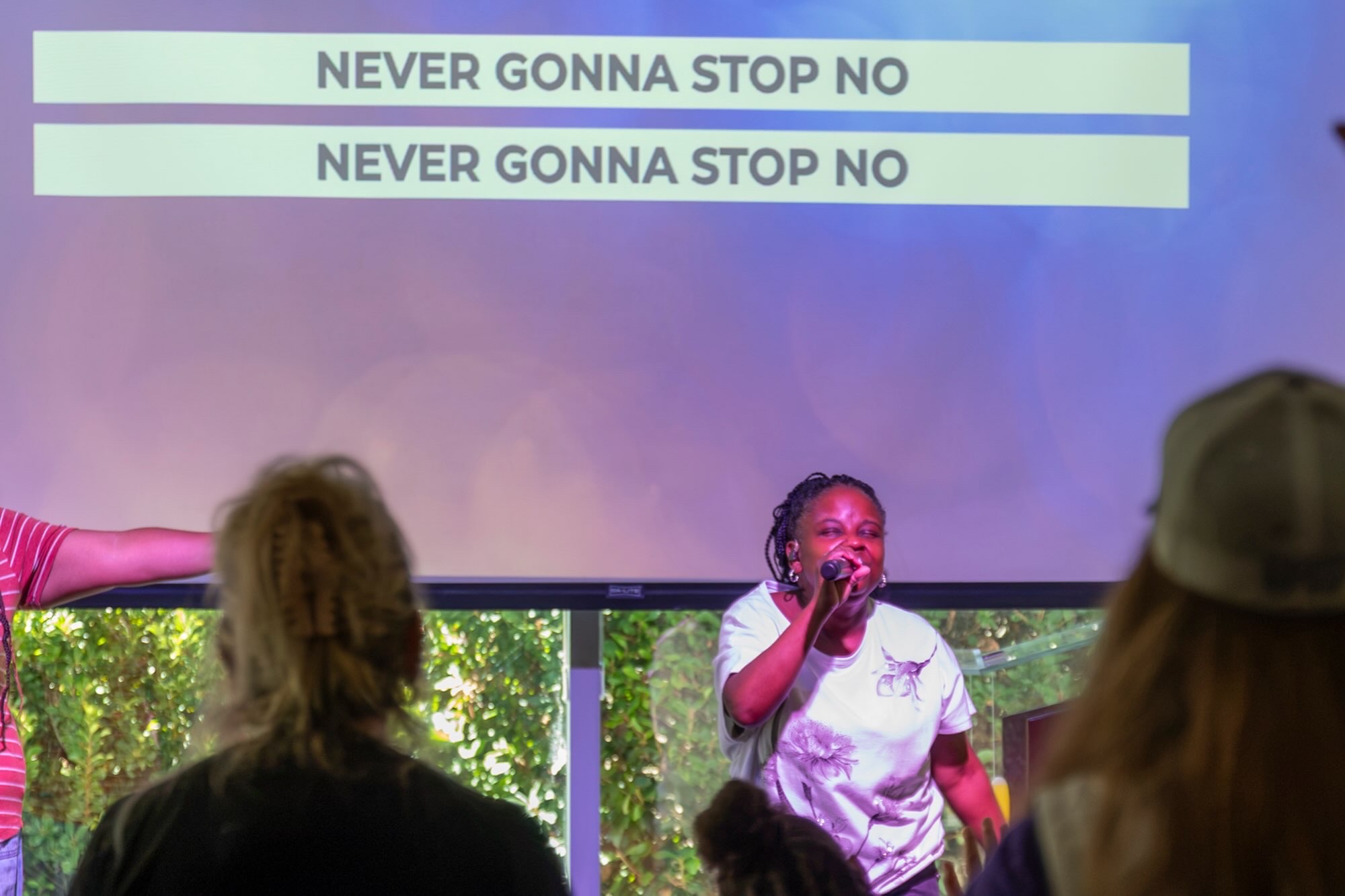 Woman leading worship at Village Baptist Church